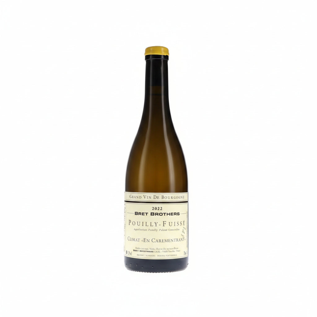 Bret Brothers Pouilly-Fuisse En Carementrant 2022 wine bottle on a table, showcasing the elegant label and glass of wine.