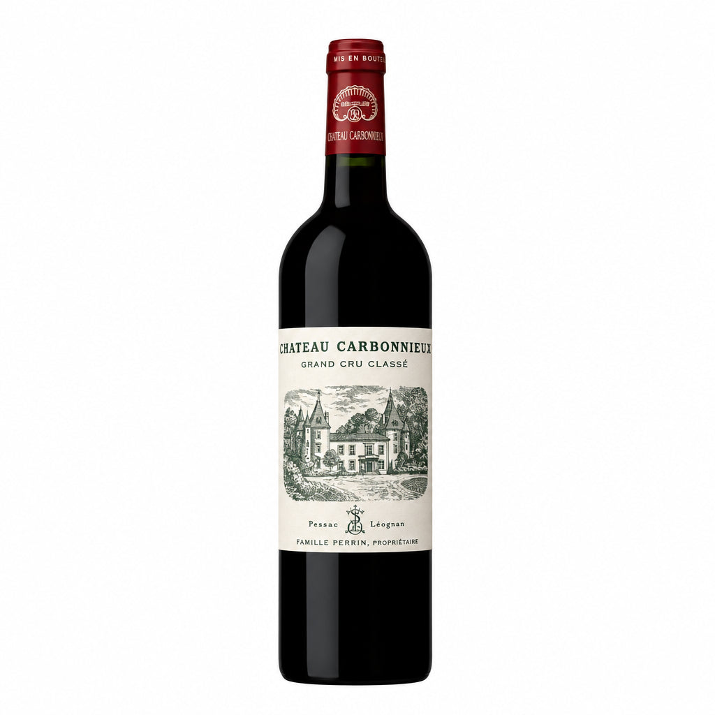 Bottle of Chateau Carbonnieux Rouge 2019 Pessac-Leognan red wine displayed on a wooden surface.