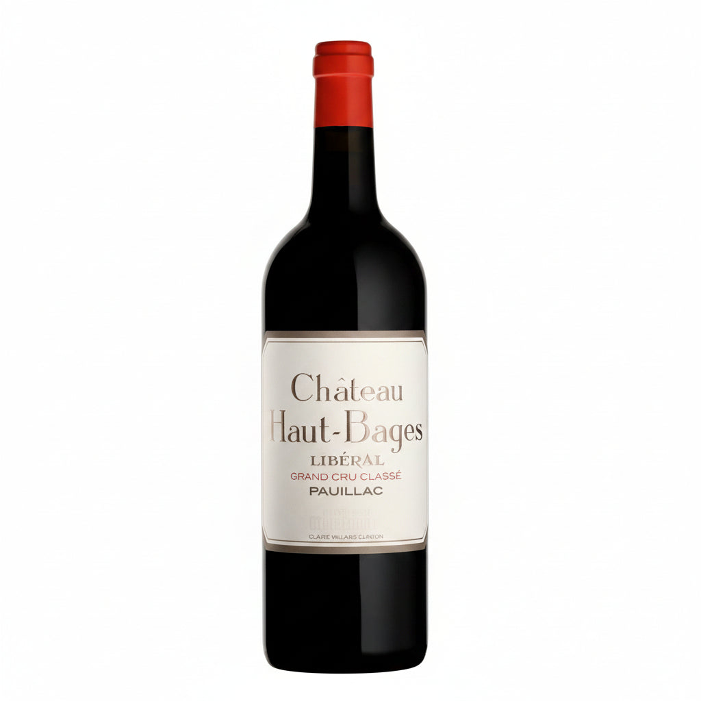 Bottle of Chateau Haut Bages Liberal Bordeaux red wine in a glass with a dark label and gold accents.