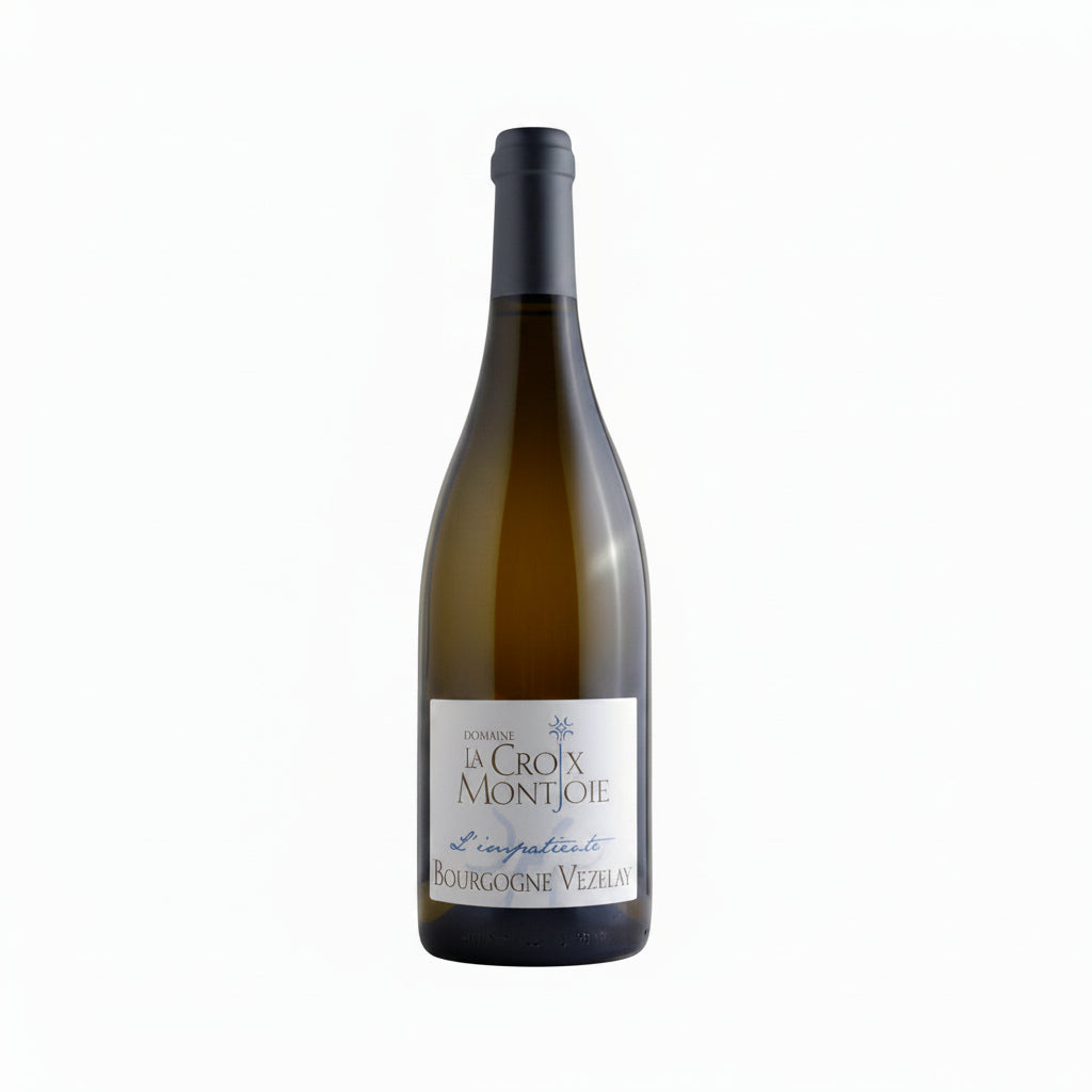 Bottle of Domaine La Croix Montjoie Vezelay L'impatiente wine with a white label and cork on a wooden surface.