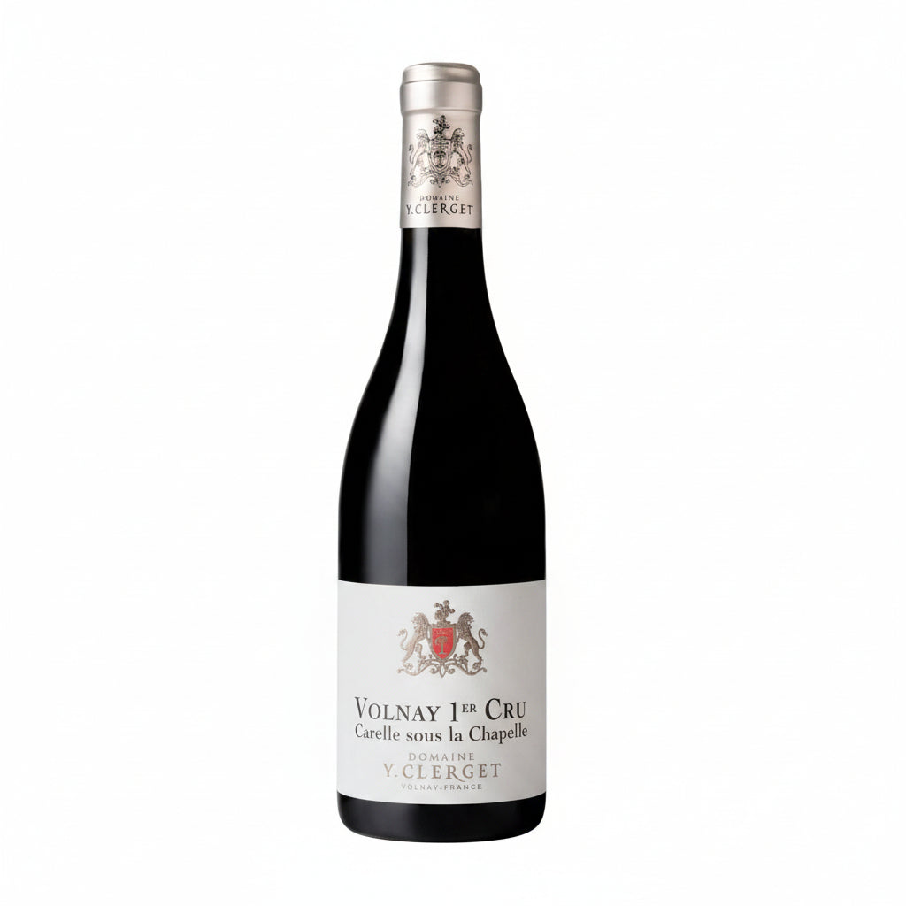 Bottle of Domaine Y. Clerget Volnay 1er Cru Carelle Sous La Chapelle wine in a glass on a vineyard background