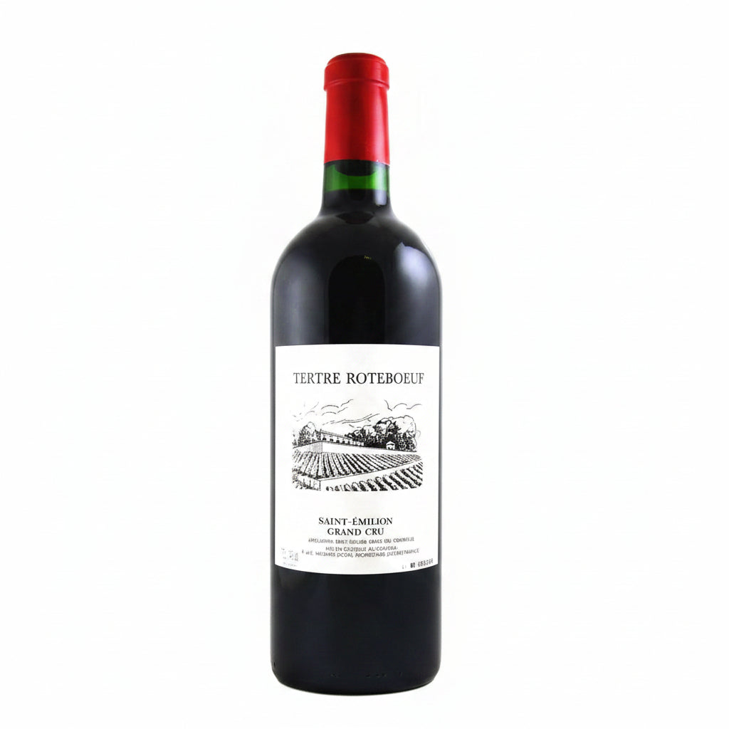 Bottle of Famille Mitjaville Tertre Roteboeuf Saint Emilion Grand Cru red wine on a wooden table.