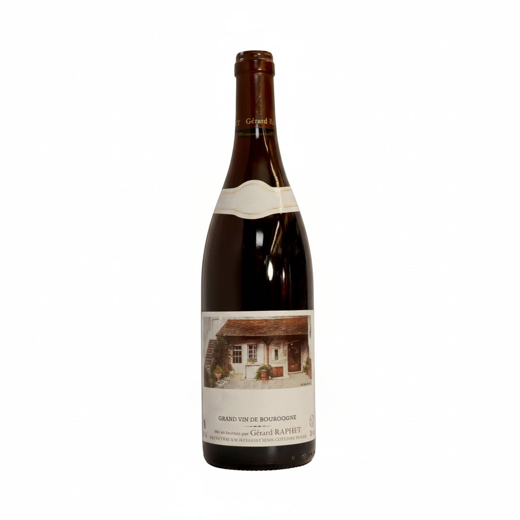 Bottle of Gerard Raphet Gevrey-Chambertin Premier Cru 1er Combottes red wine on a wooden surface with a blurred background.
