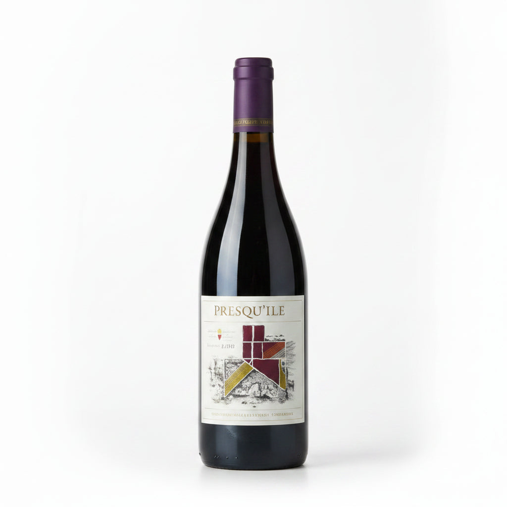 Bottle of Presquile Estate Syrah wine in a 750mL bottle with a dark label and elegant wine glass in the background.