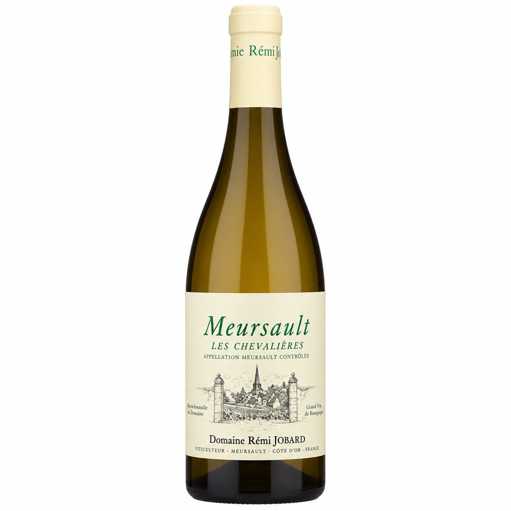 Domaine Remi Jobard Les Chevalières 2023 white wine bottle on a wooden table with a blurred vineyard background.