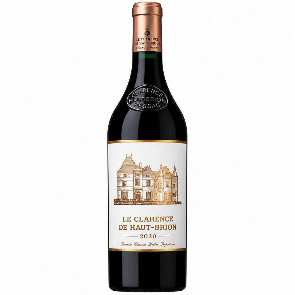 Bottle of Le Clarence De Haut Brion 2020 red wine with label visible, placed on a wooden table with a glass of wine nearby.