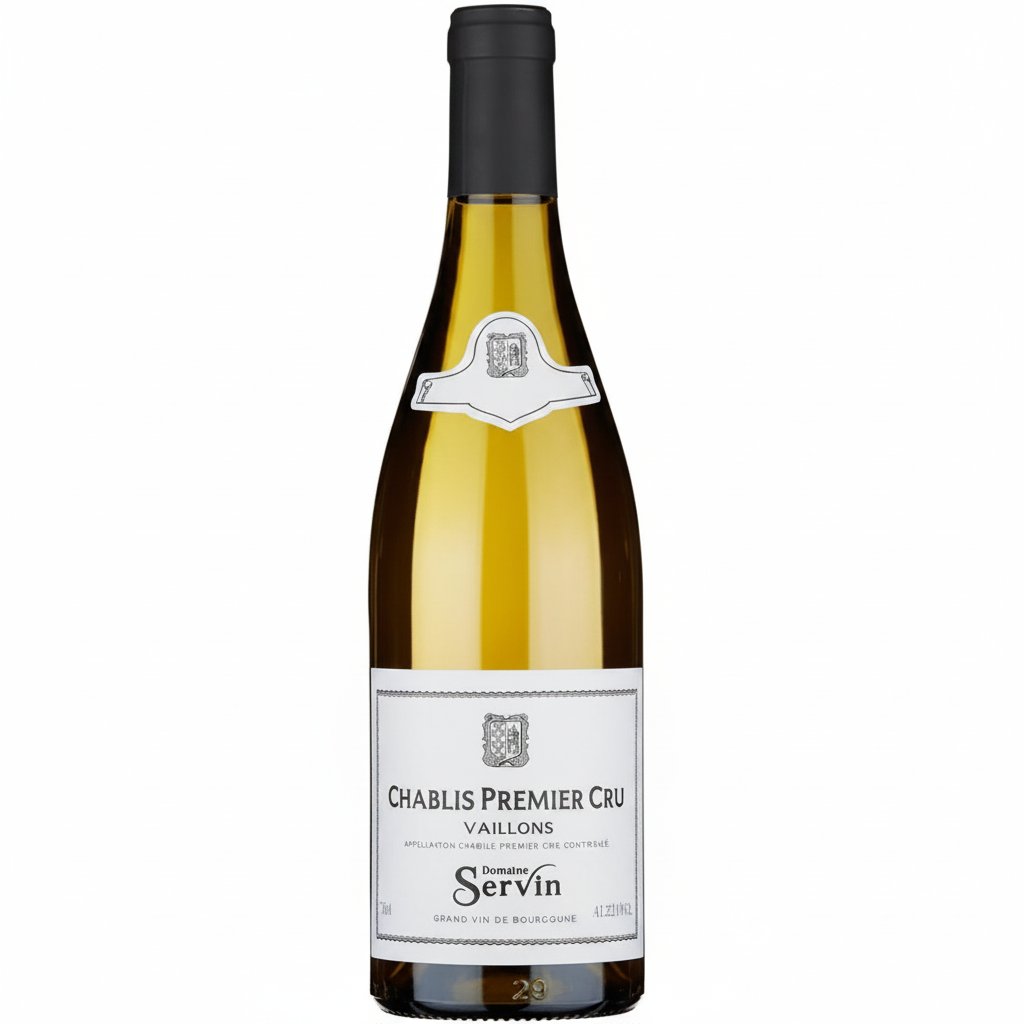 Domaine Servin Chablis Vaillons Premier Cru white wine bottle on a table with a glass of wine beside it.