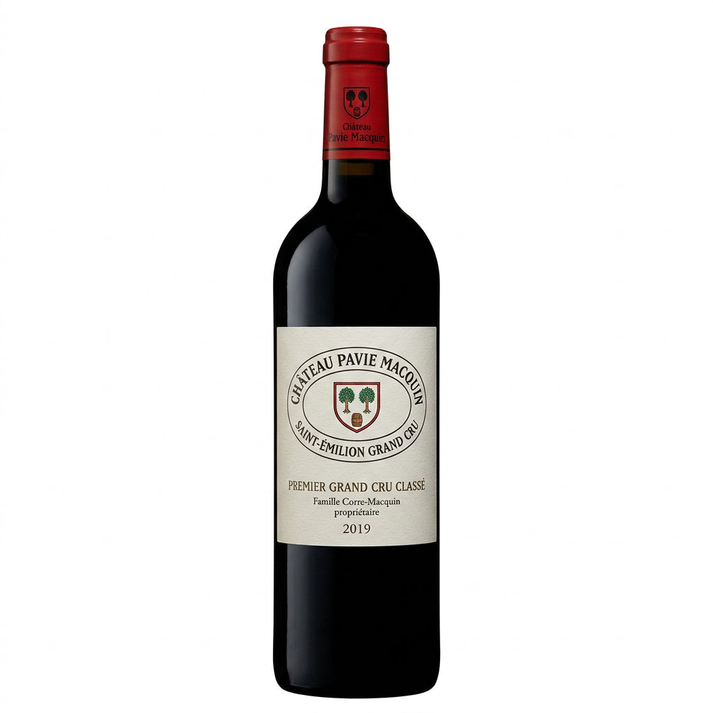 Chateau Pavie Macquin red wine bottle with label visible, placed on a wooden surface with a blurred vineyard background.