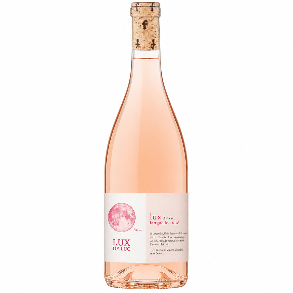 Famille Fabre Lux De Luc Rose bottle with pink wine in a glass, showcasing elegant label and rich color.