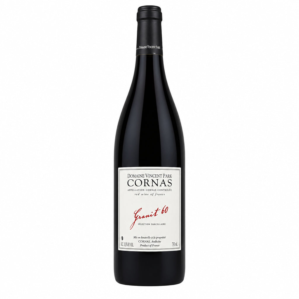 Bottle of Domaine Vincent Paris Granit 60 Cornas red wine with label visible on a wooden surface.