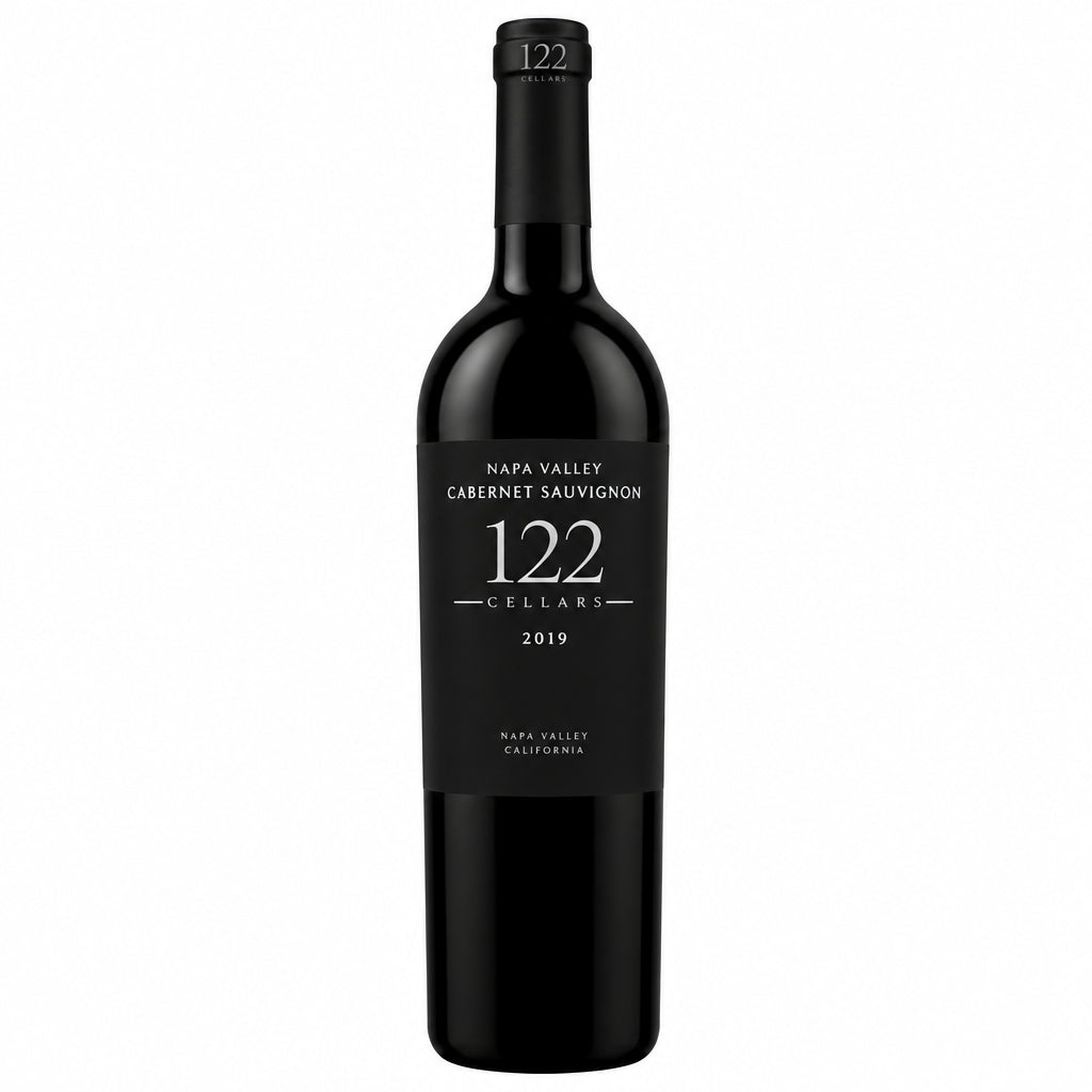 Bottle of Chateau Clos Saint Emilion Philippe 122 Grand Cru 2022 red wine on a wooden surface with a blurred vineyard background.