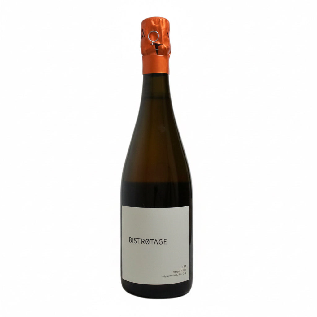 A bottle of Charles Dufour Bistrotage Champagne with a gold foil and elegant label, standing on a wooden surface.