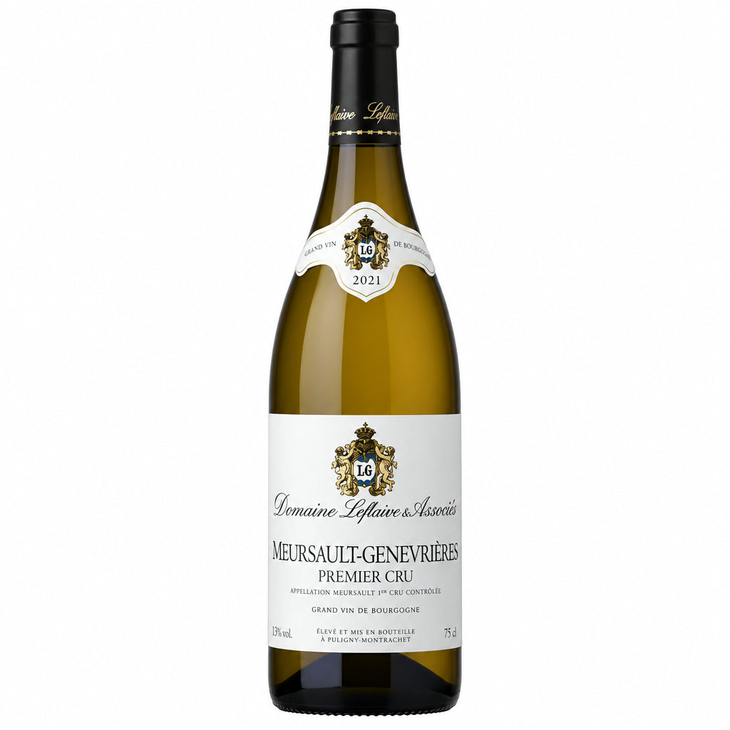 Bottle of Domaine Latour-Giraud Meursault-Genevrieres Cru white wine in a clear glass bottle on a wooden surface.