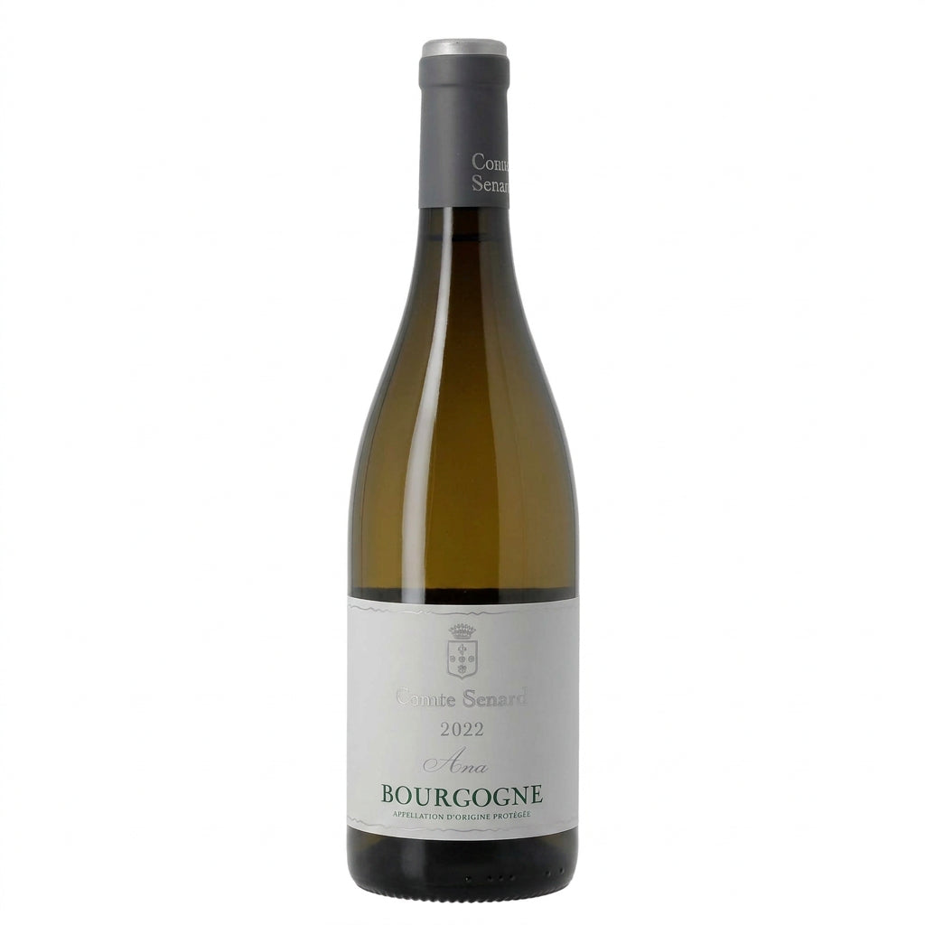 Domaine Comte Senard Bourgogne Blanc 'Ana' 2022 white wine bottle on a wooden table with a blurred vineyard background