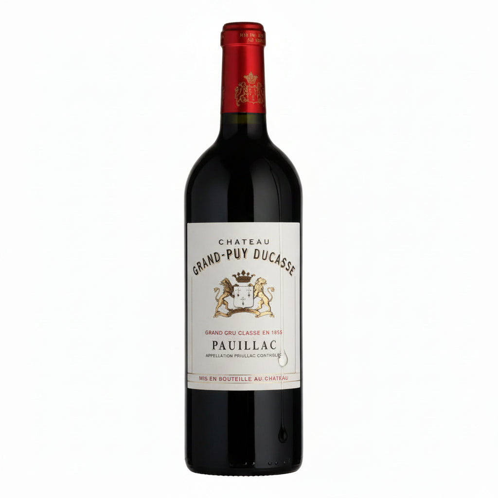 Bottle of Chateau Grand Puy Ducasse 2016 red wine with a classic label, displayed on a wooden surface.