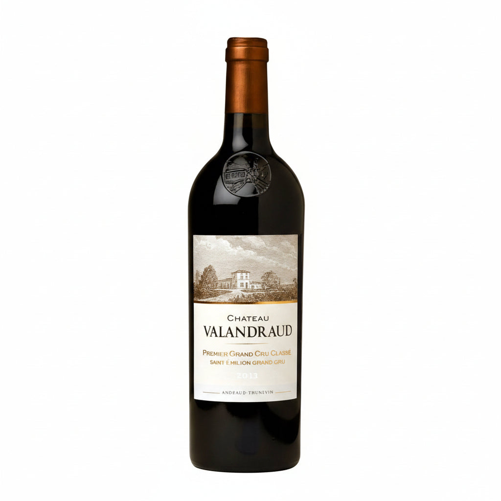 Bottle of Chateau Valandraud wine with a dark label and elegant bottle design, set against a neutral background.