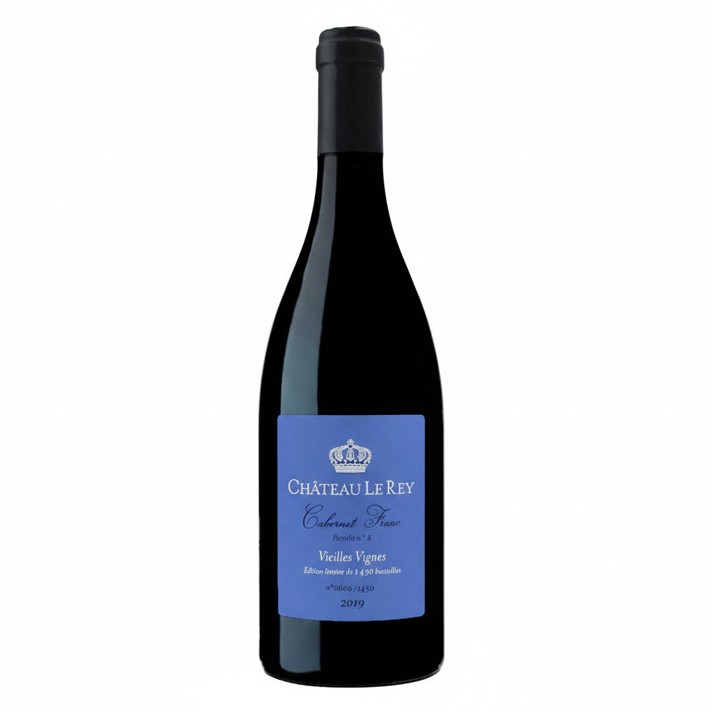 Chateau Le Rey Vieilles Vignes Cuvee Cabernet Franc wine bottle with label and glass of red wine in a rustic setting