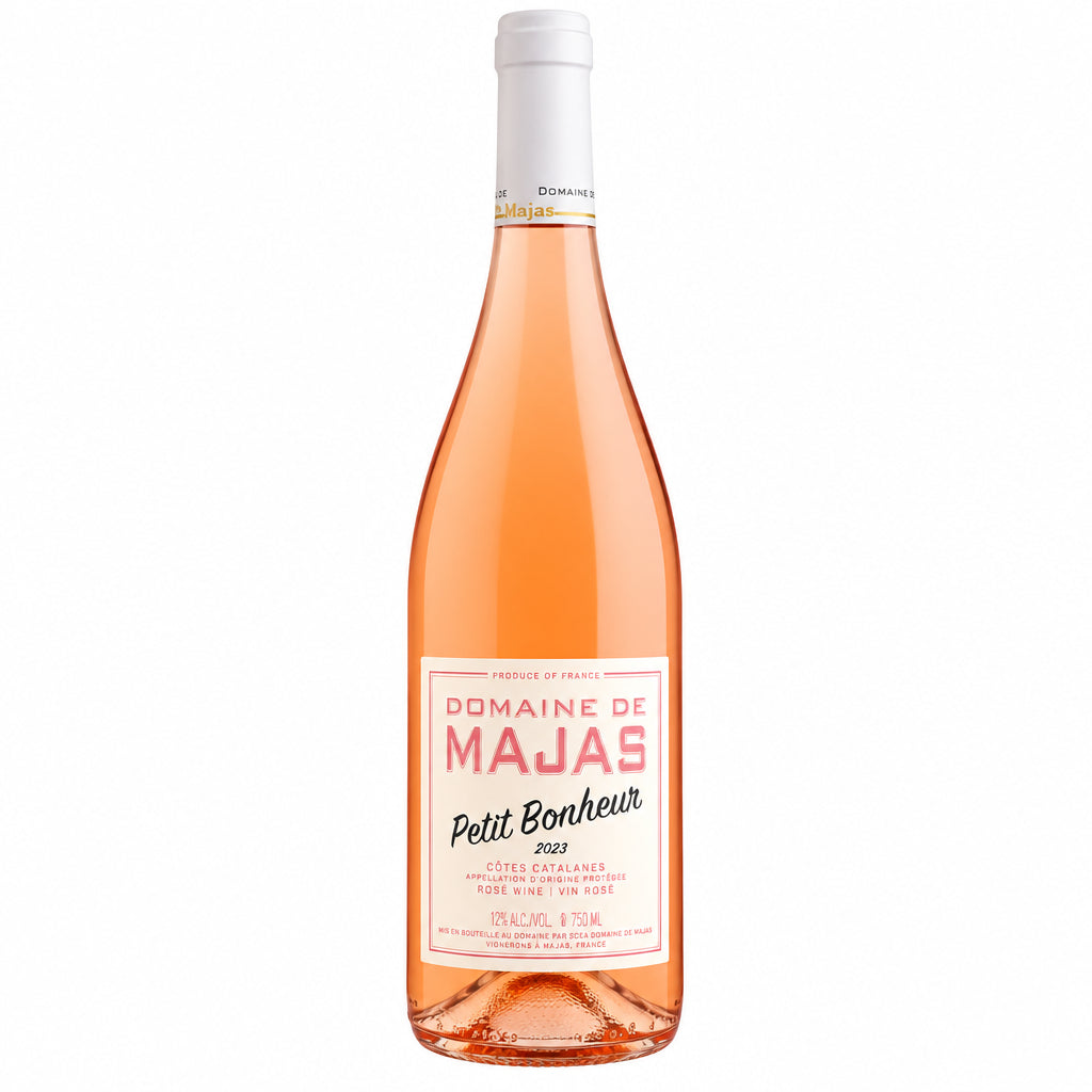 A bottle of Domaine Majas Petit Bonheur Rosé wine with a pink label, set against a neutral background.