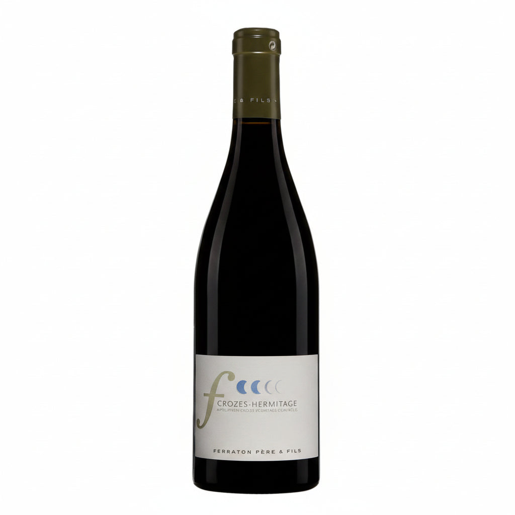 Bottle of Ferraton Crozes-Hermitage Calendes red wine with label visible, standing on a wooden surface.