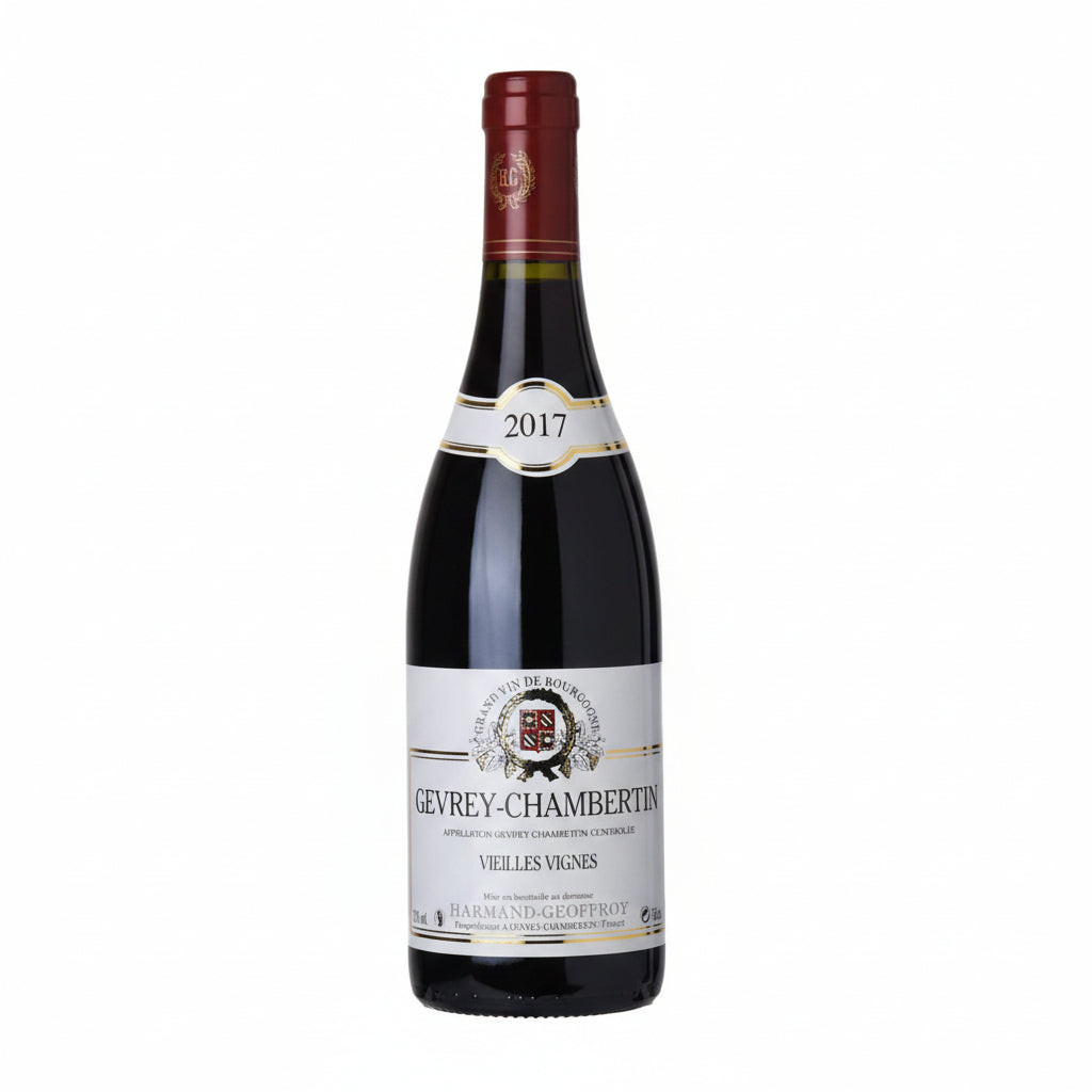 Bottle of Harmand-Geoffroy Gevrey-Chambertin red wine in a glass, showcasing the elegant label and rich color of the wine.