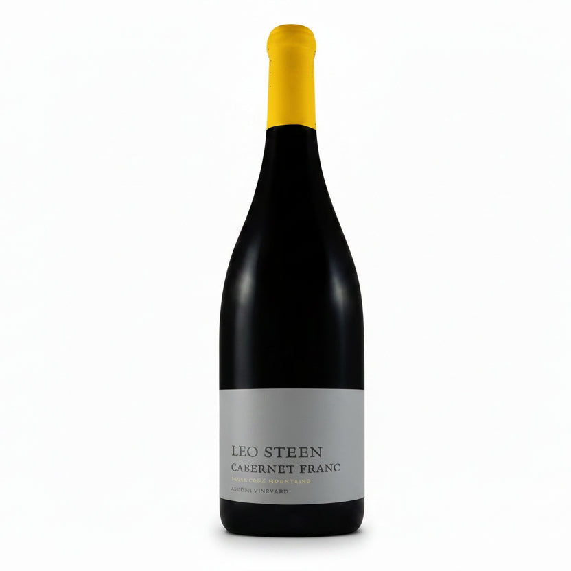 Leo Steen Cabernet Franc Ascona 750mL wine bottle with a dark label and elegant glass, showcasing the wine's rich color.