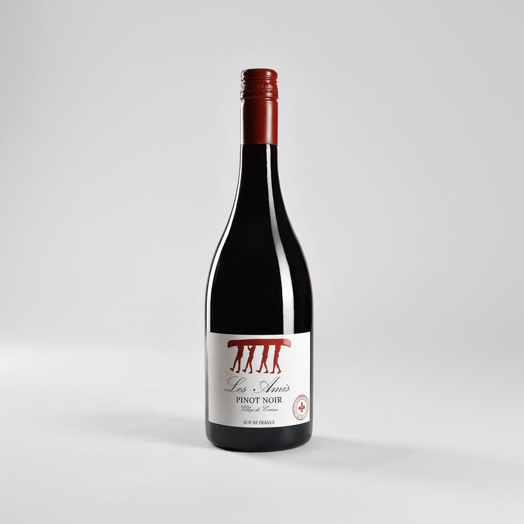 Bottle of Les Amis Pinot Noir IGP wine with label visible, showcasing its deep red color and elegant glass.