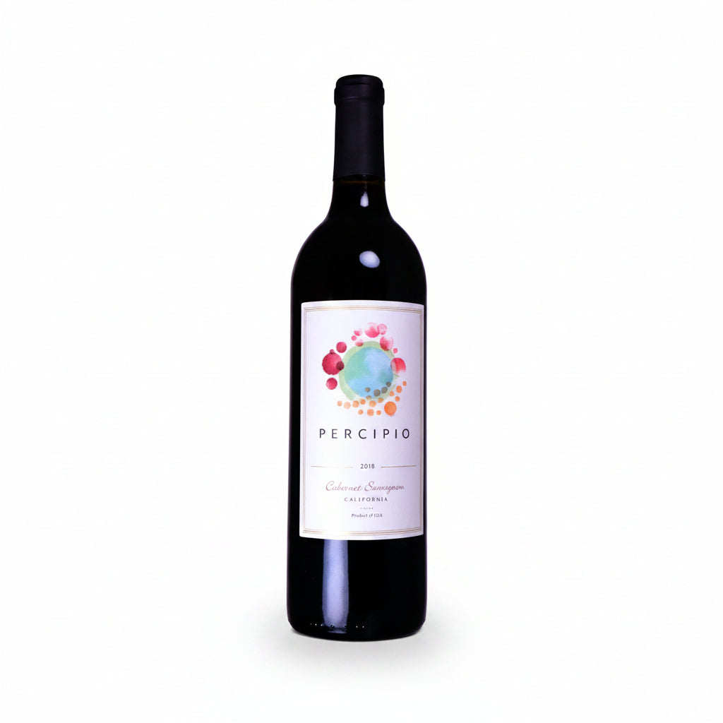 Bottle of Percipio Cab 2018 red wine in a glass, showcasing deep ruby color with a secure cork and elegant label.
