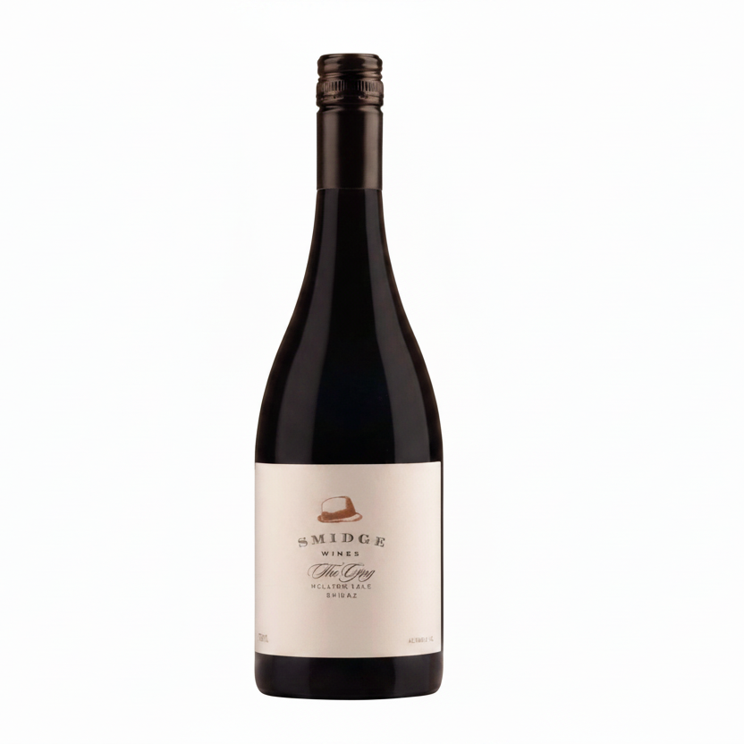 Bottle of The Ging Shiraz 750mL red wine showing the label and glass of poured wine on a wooden surface.