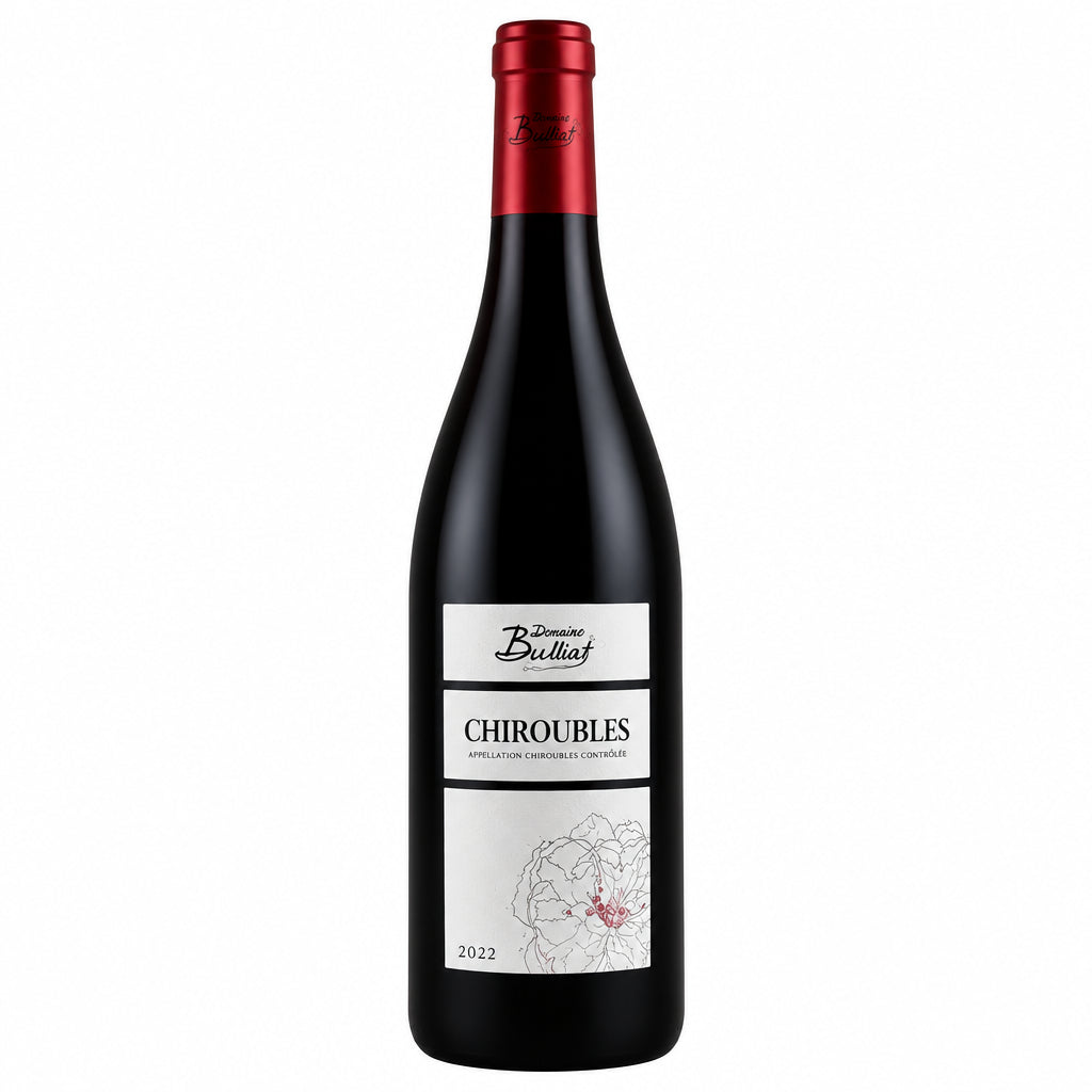 Bottle of Domaine Bulliat Chiroubles 2022 red wine with a traditional label, resting on a wooden surface.