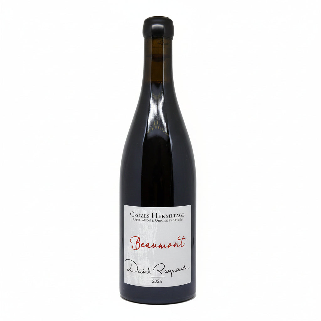 Bottle of Domaine Les Bruyeres Beaumont wine with label visible, placed on a wooden surface.