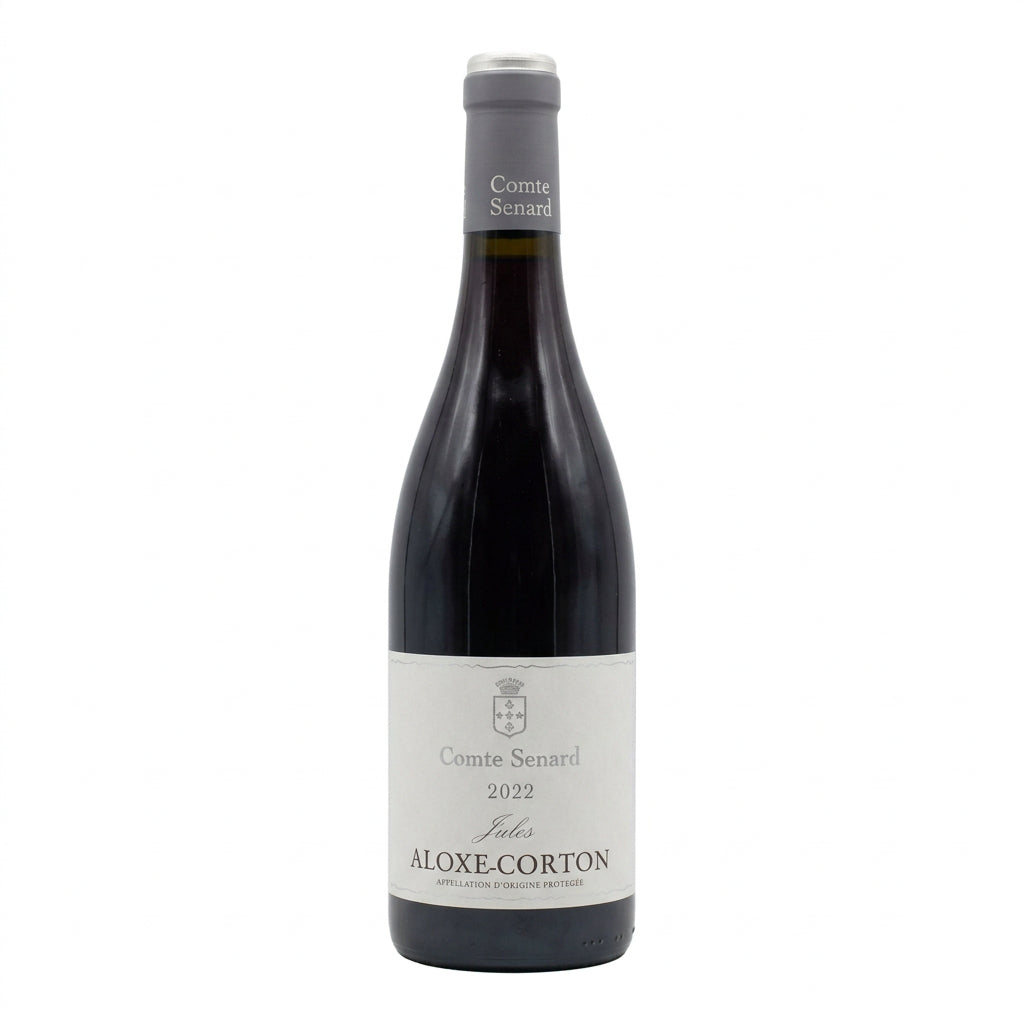 Domaine Comte Senard Aloxe Corton Cuvée Jules wine bottle with label visible, placed on a wooden surface.