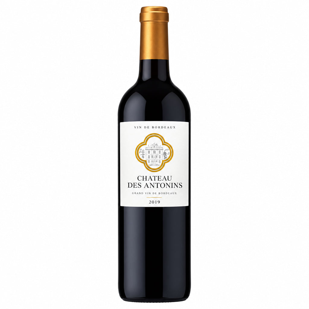 Bottle of Chateau Des Antonins Bordeaux Superieur red wine with a traditional label and foil capsule on a wooden surface.