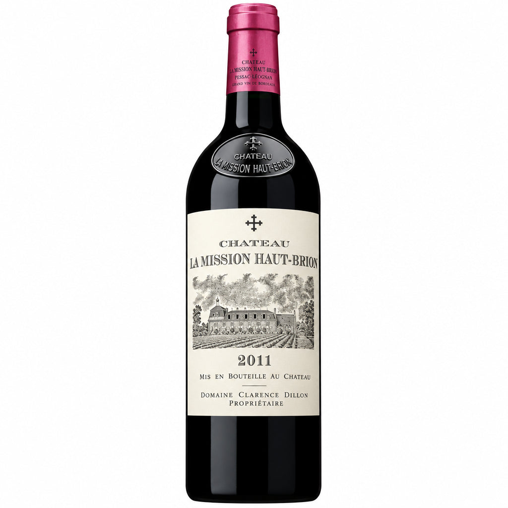 Bottle of Chateau La Mission Haut-Brion 2011 red wine with label visible and elegant glassware on a wooden table.