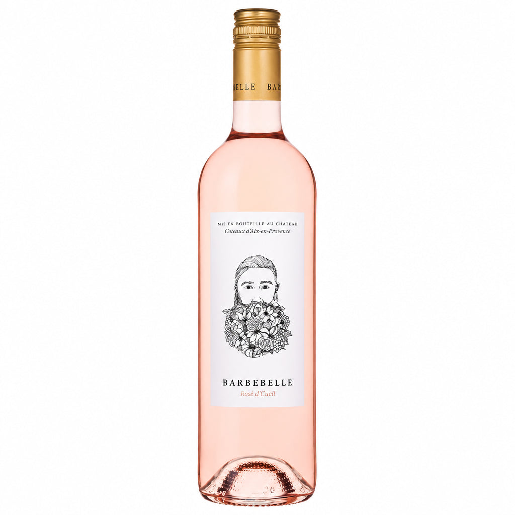 Chateau Barbebelle Cuvee Fleuris Rosé wine bottle with a pink label on a wooden surface.