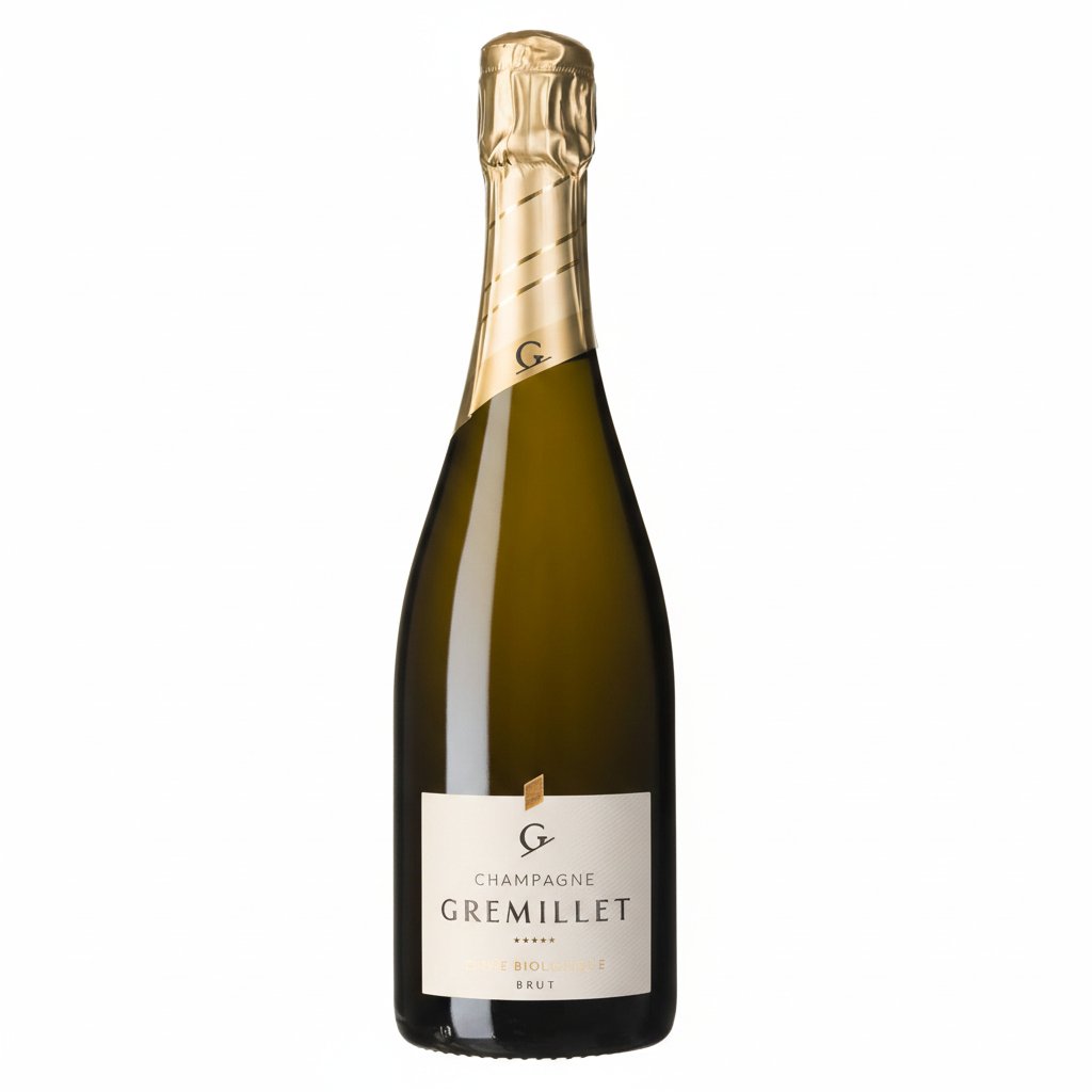 Bottle of Champagne Gremillet Organic with a gold foil top and elegant label, set against a neutral background.